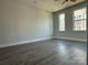 Spacious bedroom with hardwood floors and large windows at 1225 E 34Th St # Csw0419, Charlotte, NC 28205
