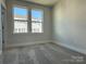 Bright bedroom with carpet, double windows, and access to a hallway at 1225 E 34Th St # Csw0419, Charlotte, NC 28205