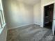 Charming bedroom with carpet flooring and access to another room at 1225 E 34Th St # Csw0419, Charlotte, NC 28205