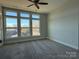 Spacious bedroom with large windows, carpet, and ceiling fan at 1225 E 34Th St # Csw0419, Charlotte, NC 28205