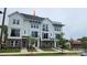 Attractive three-story townhome featuring a modern exterior design, professionally landscaped yard, and sidewalk at 1225 E 34Th St # Csw0419, Charlotte, NC 28205