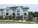Well-maintained three-story townhome showcasing modern design with brick, Hardie board, and black railing accents at 1225 E 34Th St # Csw0419, Charlotte, NC 28205
