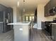 Open concept kitchen with island and stainless steel appliances at 1225 E 34Th St # Csw0419, Charlotte, NC 28205