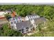 Aerial view showcases stylish townhomes nestled among mature trees, with the city skyline in the distance at 1227 E 34Th St # Csw0420, Charlotte, NC 28205