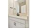 The bathroom has a white countertop, cabinets, black fixtures, and a large mirror at 1227 E 34Th St # Csw0420, Charlotte, NC 28205