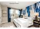 A stylish bedroom with luxury carpet, a custom-painted accent wall, and views of the surrounding neighborhood at 1227 E 34Th St # Csw0420, Charlotte, NC 28205