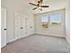 An open and airy bedroom featuring neutral carpet, three large windows, and two separate closets at 1227 E 34Th St # Csw0420, Charlotte, NC 28205