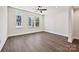 A bright and airy bedroom featuring sleek wood flooring, recessed lighting, and three large windows at 1227 E 34Th St # Csw0420, Charlotte, NC 28205