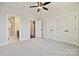 This bedroom features a ceiling fan, and access to a bathroom and staircase at 1227 E 34Th St # Csw0420, Charlotte, NC 28205