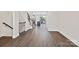 Spacious entryway features wood-look flooring and staircase with modern iron railings at 1227 E 34Th St # Csw0420, Charlotte, NC 28205