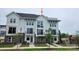 Charming, new construction townhome featuring a modern white and brick facade with private balconies and well manicured landscaping at 1227 E 34Th St # Csw0420, Charlotte, NC 28205