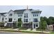 Charming, new construction townhome featuring a modern white and brick facade with private balconies and well manicured landscaping at 1227 E 34Th St # Csw0420, Charlotte, NC 28205