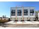 Rear exterior of a townhome with garages, concrete driveways and a mix of white and gray siding at 1227 E 34Th St # Csw0420, Charlotte, NC 28205