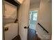 Convenient laundry area featuring a stacked washer and dryer and easy access to the upstairs living area at 1227 E 34Th St # Csw0420, Charlotte, NC 28205
