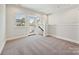 Bright living room featuring neutral walls, carpet and a glass door leading to an outdoor space at 1227 E 34Th St # Csw0420, Charlotte, NC 28205