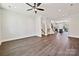 A spacious open-concept living room features sleek wood flooring, recessed lighting, and an open staircase at 1227 E 34Th St # Csw0420, Charlotte, NC 28205