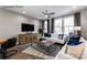 Comfortable living room featuring hardwood flooring, a ceiling fan, neutral walls, and modern decor at 1227 E 34Th St # Csw0420, Charlotte, NC 28205