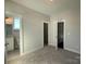 Spacious bedroom with neutral walls, offering an ensuite bathroom and walk-in closet at 1229 E 34Th St # Csw0421, Charlotte, NC 28205