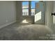 Bright bedroom featuring fresh paint and large windows that fill the room with sunlight at 1229 E 34Th St # Csw0421, Charlotte, NC 28205