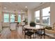 Bright breakfast nook with a marble table and seating by a large window with view to the kitchen at 1229 E 34Th St # Csw0421, Charlotte, NC 28205