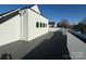 An expansive outdoor deck shows clean white siding on a modern home with a black roof at 1229 E 34Th St # Csw0421, Charlotte, NC 28205