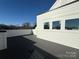 A modern home featuring a spacious deck with views and clean white siding under a clear blue sky at 1229 E 34Th St # Csw0421, Charlotte, NC 28205