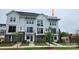 Modern townhouse showcasing a white exterior, black trim, a cozy balcony, and a well maintained front yard at 1229 E 34Th St # Csw0421, Charlotte, NC 28205