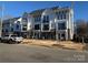 New townhomes showcase brick accents, white siding, and black balconies, with street parking available at 1229 E 34Th St # Csw0421, Charlotte, NC 28205