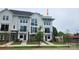New construction townhouse with a modern white and gray exterior, black trim, balcony and well manicured lawn at 1229 E 34Th St # Csw0421, Charlotte, NC 28205