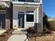 Townhouse entrance featuring a gray front door, white trim, and landscaped front yard at 1229 E 34Th St # Csw0421, Charlotte, NC 28205