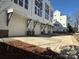 The row of new townhomes showcases two-car garages and neutral exterior color schemes at 1229 E 34Th St # Csw0421, Charlotte, NC 28205