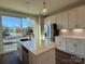 Bright kitchen with white cabinets, stainless steel appliances, quartz countertops, and a large island at 1229 E 34Th St # Csw0421, Charlotte, NC 28205