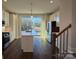 Bright kitchen features an island with white countertops, stainless appliances, and modern pendant lighting at 1229 E 34Th St # Csw0421, Charlotte, NC 28205
