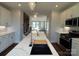 Open floor plan from kitchen with island sink looking out to the Gathering room and staircase to the second level at 1229 E 34Th St # Csw0421, Charlotte, NC 28205