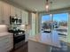 Modern kitchen showcasing stainless steel appliances, white cabinetry, and a quartz countertop kitchen island at 1229 E 34Th St # Csw0421, Charlotte, NC 28205