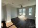 Bright living room showcasing hardwood floors and natural light pouring in through a set of three windows at 1229 E 34Th St # Csw0421, Charlotte, NC 28205