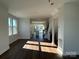 Bright, open-concept living room features wood floors, large windows, and seamless flow into the kitchen and staircase at 1229 E 34Th St # Csw0421, Charlotte, NC 28205