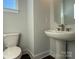 Well-lit powder room features a pedestal sink, modern fixtures, and a comfortable layout for guests at 1229 E 34Th St # Csw0421, Charlotte, NC 28205