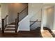 Elegant staircase showcases wood treads, iron railings, and natural light, connecting the home's multiple levels seamlessly at 1229 E 34Th St # Csw0421, Charlotte, NC 28205