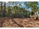 New home backyard featuring dirt lawn, wooden deck, and mature trees at 1235 Ebinport Rd, Rock Hill, SC 29732
