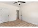 Bedroom with wood-look flooring, ceiling fan, and an open doorway to another room at 1235 Ebinport Rd, Rock Hill, SC 29732