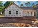 New construction home featuring brick foundation, steps to front door, and prepared yard for final grading at 1235 Ebinport Rd, Rock Hill, SC 29732