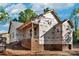 New home exterior under construction featuring building wrap, brick foundation and covered porch at 1235 Ebinport Rd, Rock Hill, SC 29732