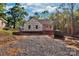 New home exterior under construction featuring building wrap and gravel driveway at 1235 Ebinport Rd, Rock Hill, SC 29732