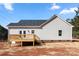 Rear view of new home featuring wooden deck, vinyl siding and brick foundation at 1235 Ebinport Rd, Rock Hill, SC 29732