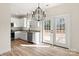 Bright kitchen features white cabinets, stainless steel appliances, granite countertops and a modern black chandelier at 1235 Ebinport Rd, Rock Hill, SC 29732