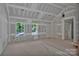 Spacious living room features drywall construction, large windows, ample natural light, and smooth concrete flooring at 1235 Ebinport Rd, Rock Hill, SC 29732