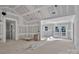 Large living room with vaulted ceiling and drywall, ready for paint, has adjacent doors leading to outdoor spaces at 1235 Ebinport Rd, Rock Hill, SC 29732