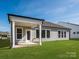 A covered outdoor patio overlooks the backyard's well-maintained lawn at 3111 Vermillion Dr, Harrisburg, NC 28075