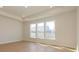 Bright room with tray ceiling, recessed lights, light wood floors and three large windows at 3111 Vermillion Dr, Harrisburg, NC 28075